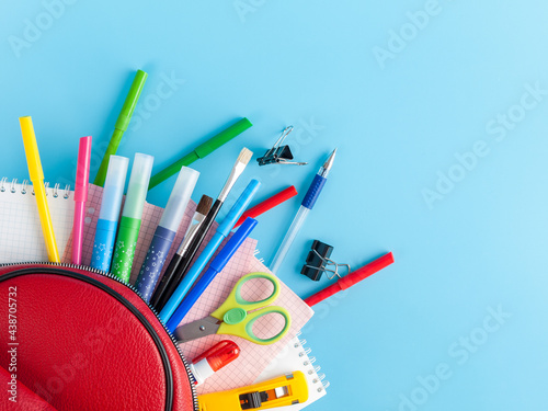 stationery next to the bag backpack, school supplies for students children and students, soon to school, back to school, school and student theme photo