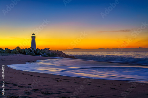 The Walton Lighthouse at the Santa Cruz, CA harbor at sunset.