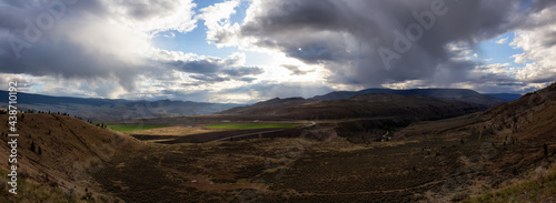 Panoramic View of Desert Mountain Canadian Nature Landscape. Colorful Sunset Sky. Taken in Savona near Kamloops, British Columbia, Canada. Background Panorama