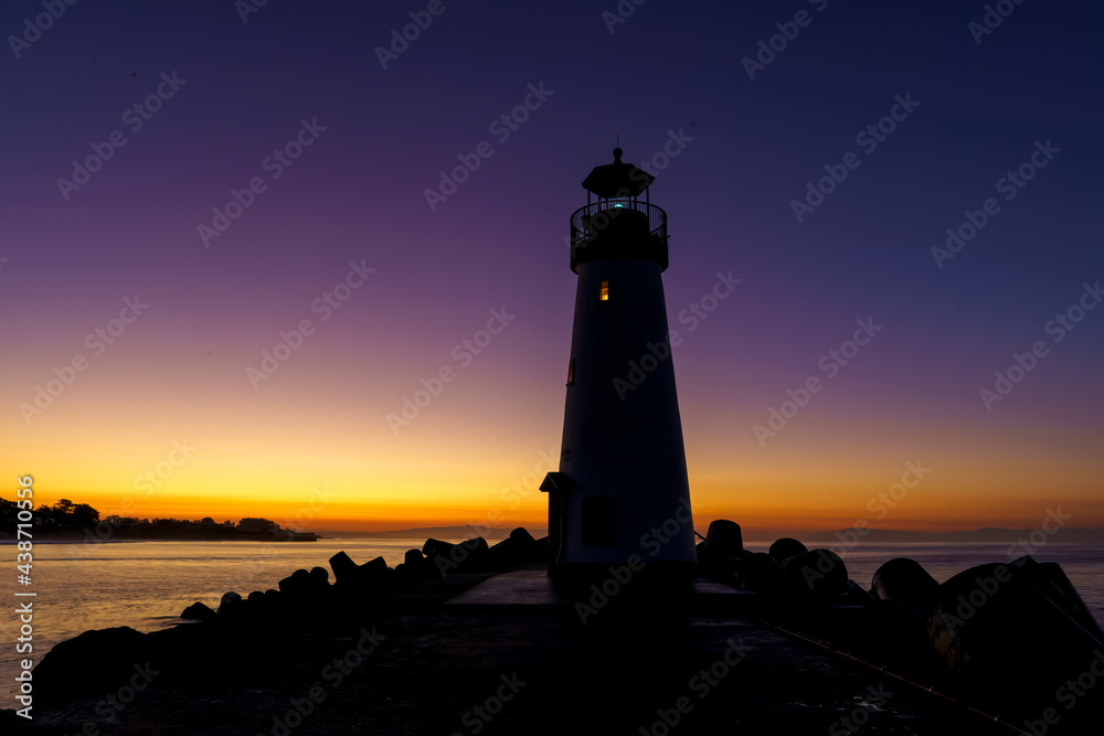 The Walton Lighthouse at the Santa Cruz, CA harbor at sunset.