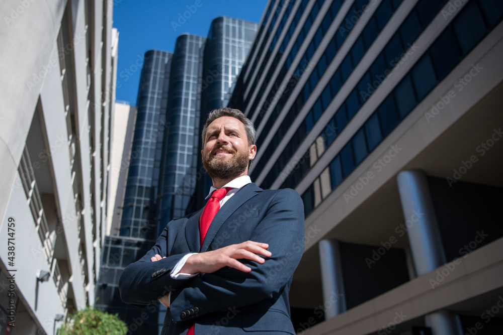 Executive businessman. Portrait of ceo near modern office in suit. Happy leader standing in front of company building. Executive businessman. Portrait of ceo near modern office in suit. Happy leader standing in front of company building.