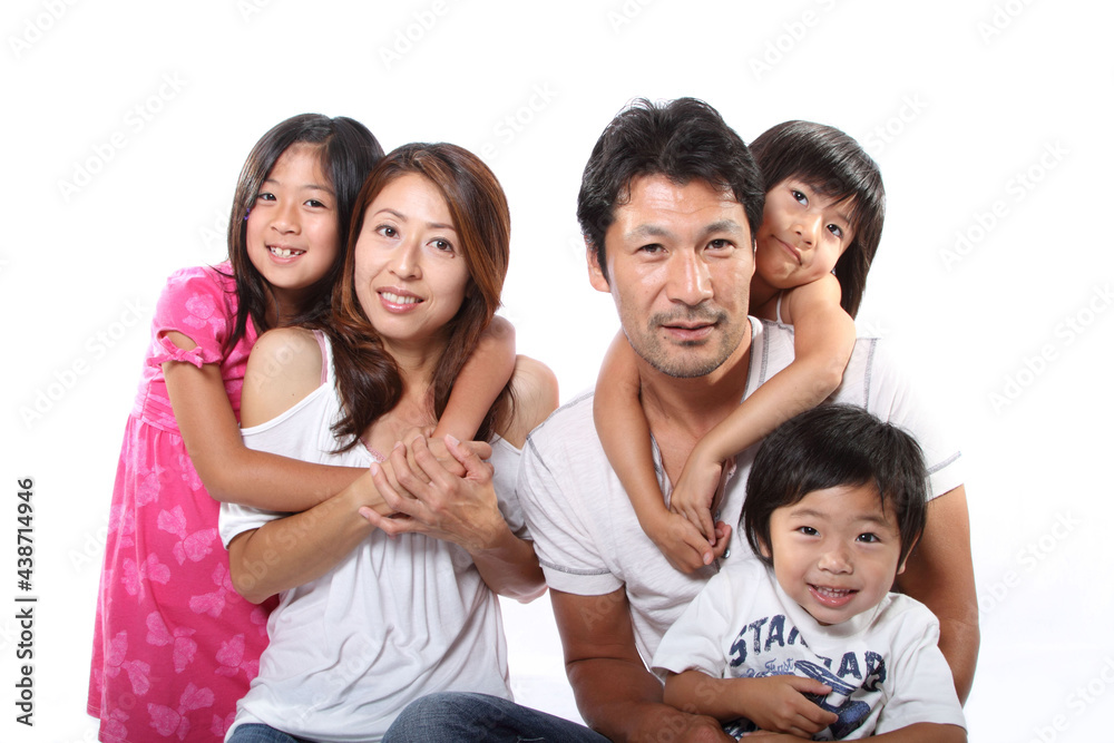 A happy Japanese family relaxing in the living room A happy Japanese family relaxing in the living room