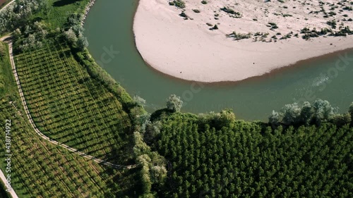 Aerial view of a big bend of the river Sesia while flying over the countryside below in Langosco, Po Valley, Italy. photo