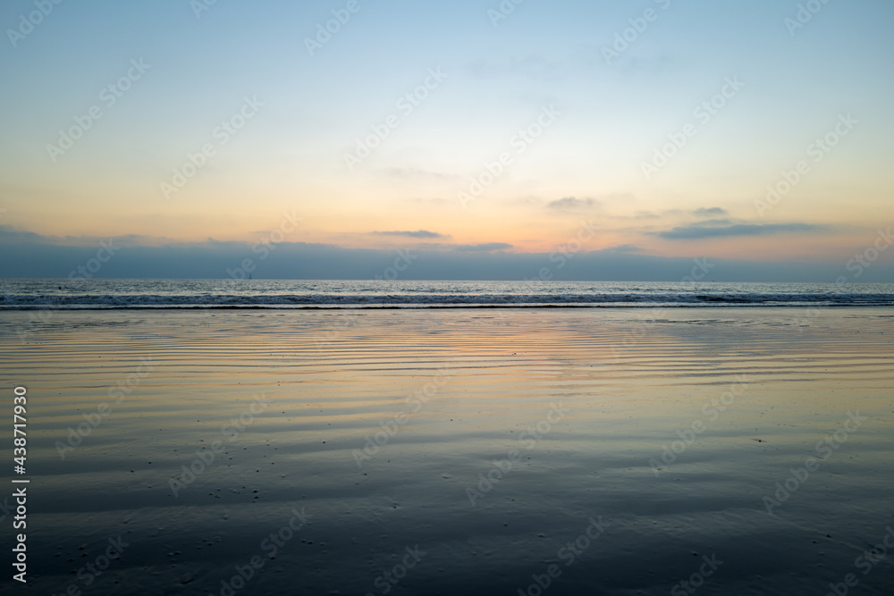 Tropical beach sea ocean with sunset or sunrise for summer travel vacation. Ocean seascape.