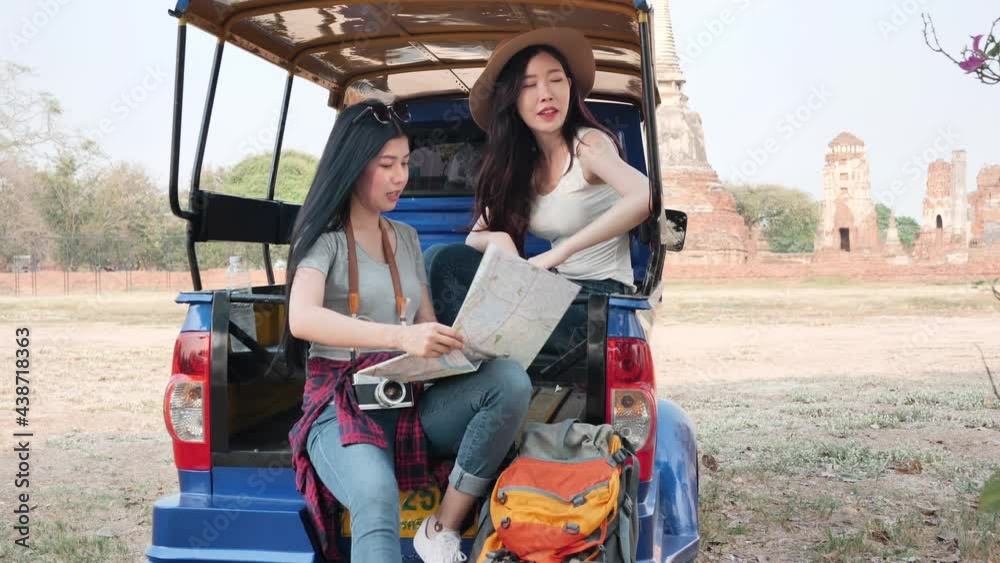 Beautiful Asian two women looking at map travel on Car Tuk Tuk Background world heritage city Ayutthaya, Thailand. Woman backpacker freedom traveling on holidays The old town. Slow Motion Beautiful Asian two women looking at map travel on Car Tuk Tuk Background world heritage city Ayutthaya, Thailand. Woman backpacker freedom traveling on holidays The old town. Slow Motion