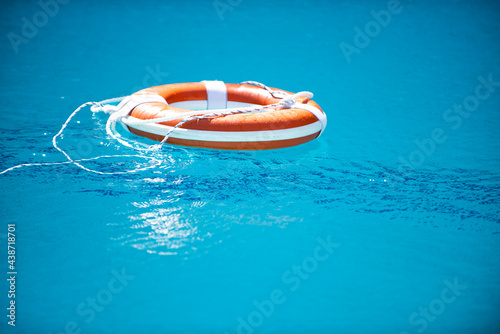 Help and drowning concept. Life saver ring floating in the water.