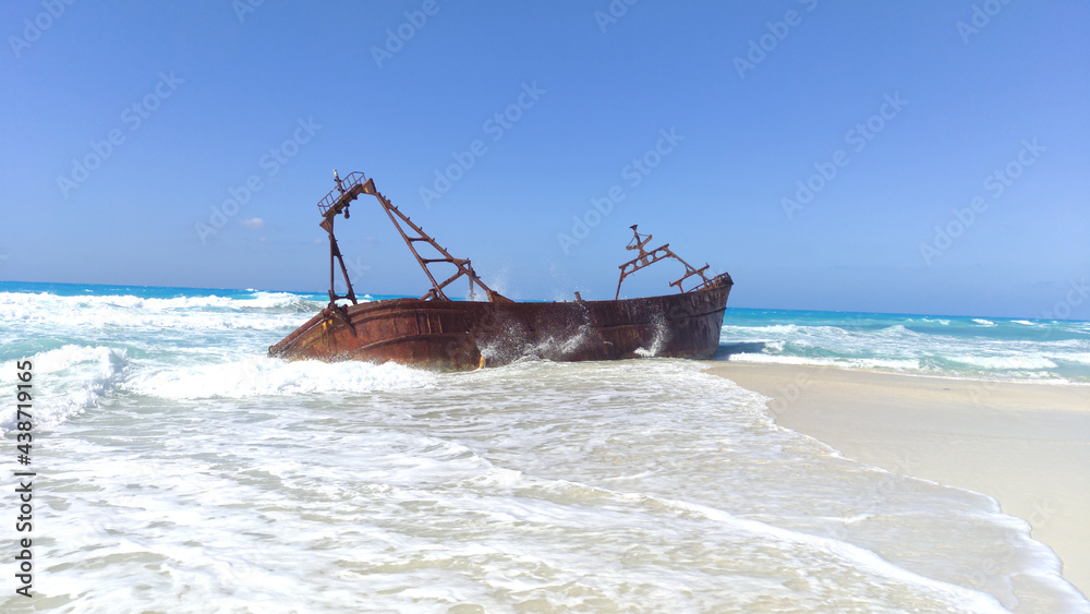 A Picture of a boat on the white sand of Alex beach 
 .shipwreck on the beach