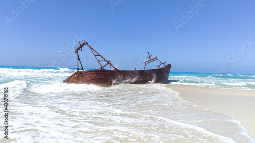 A Picture of a boat on the white sand of Alex beach .shipwreck on the beach
