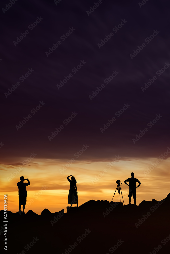 Silhouette of photographers on sunset with copy space for text
