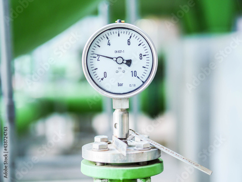 Pressure gauge of measuring instrument close up in industry zone at power plant with closed up photo