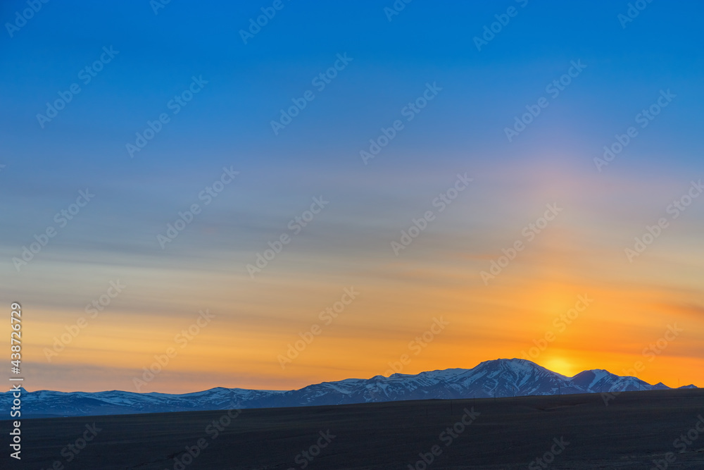 Beautiful sunset in mountains, in Kosh-Agach, Altai Republic, Russia. Bright sun and blue sky