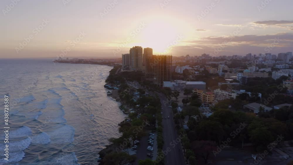 Flying over Malecon in Santo Domingo at sunset. Aerial drone forward