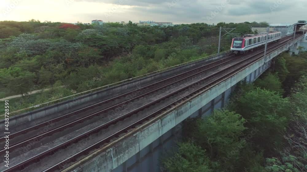 Risky aerial low flight crossing train arriving running on railway Risky aerial low flight crossing train arriving running on railway