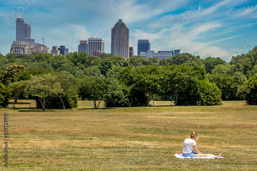 Young lady enjoying the park with views of the Raleigh skyline