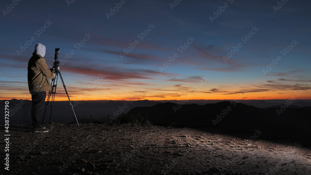 Naklejka premium Fotógrafo crepúsculo