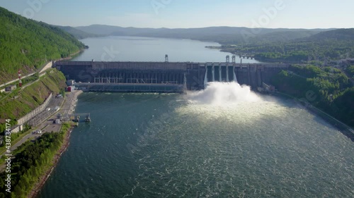 Hydroelectric dam on the river, water discharge from the reservoir,  aerial video footage
