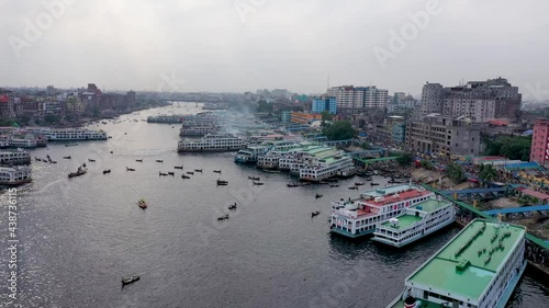 Aerial view of a busy wharf along Buriganga river with many sailing boats docked at shipyard in Keraniganj city, Dhaka state, Bangladesh. photo