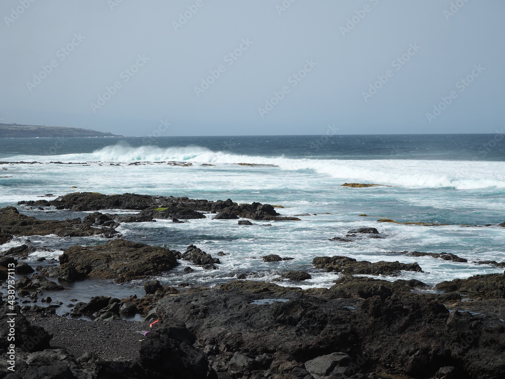 Volcanic coast of the Atlantic Ocean. Waves crash against black rocks. Tenerife, Canary Islands Volcanic coast of the Atlantic Ocean. Waves crash against black rocks. Tenerife, Canary Islands