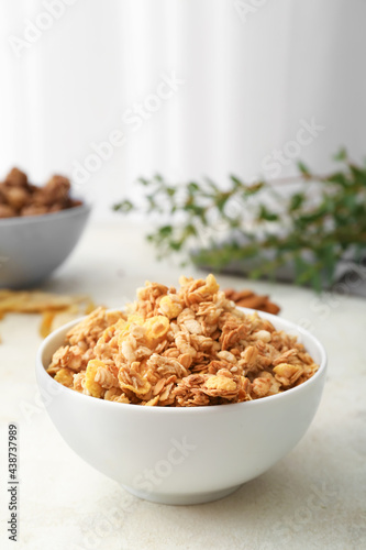 Bowl with tasty granola on table