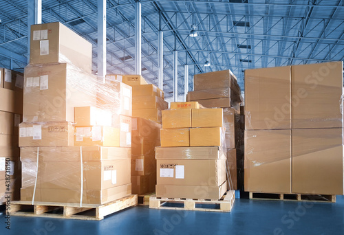 Stacked of Package Boxes on Pallets at Storage Warehouse. Shipment Boxes. Cargo Export- Import. Shipping Warehouse Logistics.	
