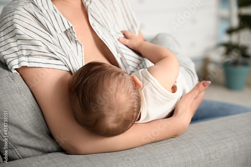 Young woman breastfeeding h...