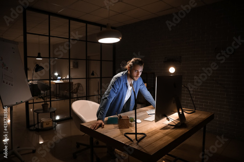 Handsome man working in off...