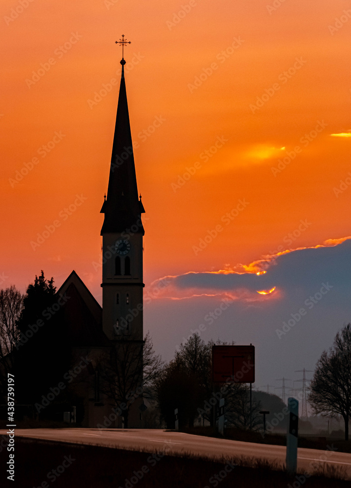 Beautiful sunset with a church silhouette near Wallerdorf, Bavaria, Germany