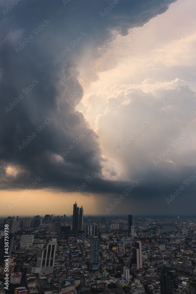 Dramatic raining sky over Bangkok, Thailand.  City Skyline with raining cloud