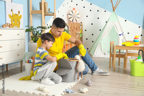 Father and son cleaning the...