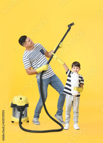 Father and son with vacuum ...