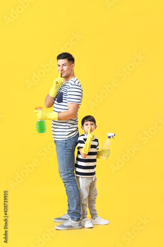 Father and son with deterge...