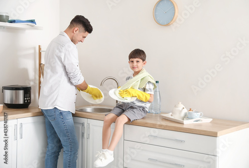 Father and son washing dish...