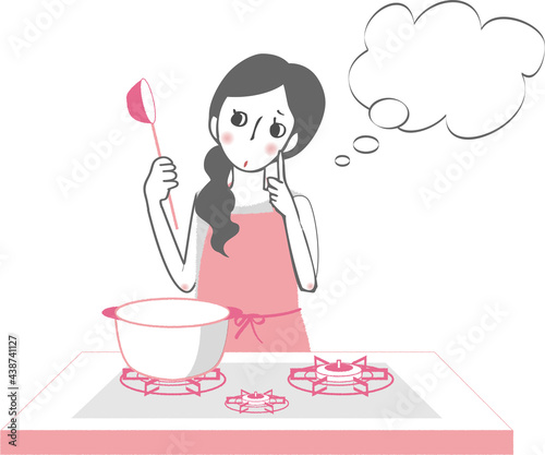 ガスコンロで料理中のエプロンをした女性。