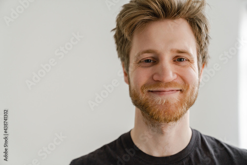 White ginger man with beard smiling and looking at camera