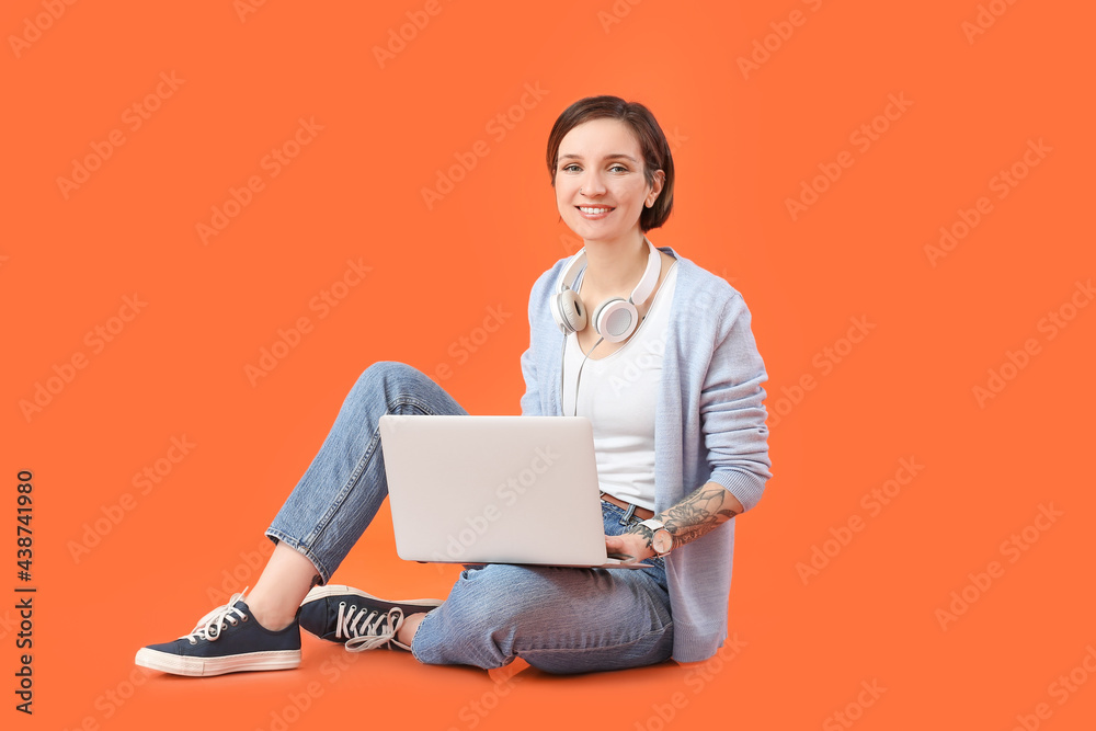 Female programmer with laptop on color background Female programmer with laptop on color background