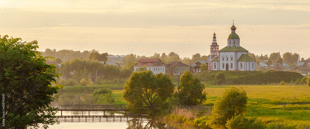 Summer sunset in old russian town of golden ring called Suzdal. Beautiful landscape, orthodox church on the hill.