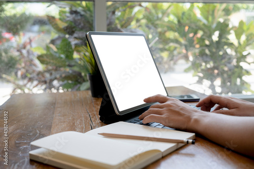 Close up view of student woman using computer tablet at the library.