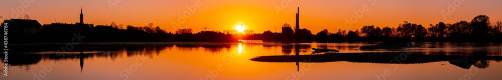 High resolution stitched panorama of a beautiful sunset with reflections near Pleinting, Danube, Bavaria, Germany