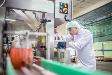 workers in factory checking products. workers inspecting production line at drinks production factory. working Concept