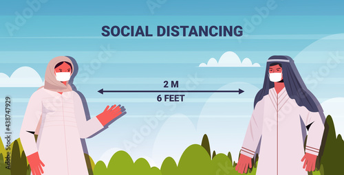 arabic couple in protective masks keeping distance to prevent coronavirus social distancing concept