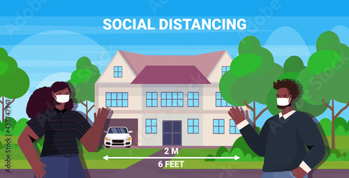 couple in protective masks keeping distance to prevent coronavirus social distancing concept