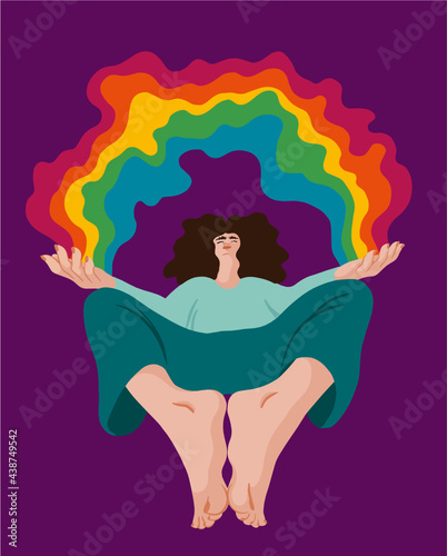 Woman in a yogic position opening her arms to a colorful rainbow and looking up to it. Frog persepctive.