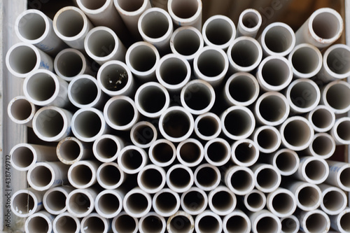Background of white plastic pipes used at the building site.
