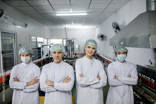 Groub workers in production line at drinks production factory background photo