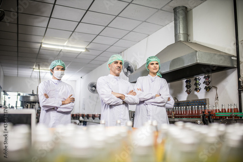 Groub workers in production line at drinks production factory background photo