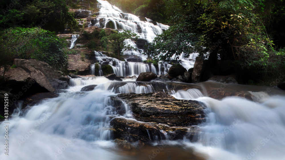 Fototapeta premium Beautiful waterfall in green forest in jungle at Ching Mai Thailand