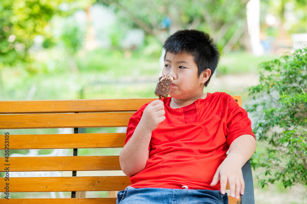 asian boy eating ice cream, summer season asian boy eating ice cream, summer season