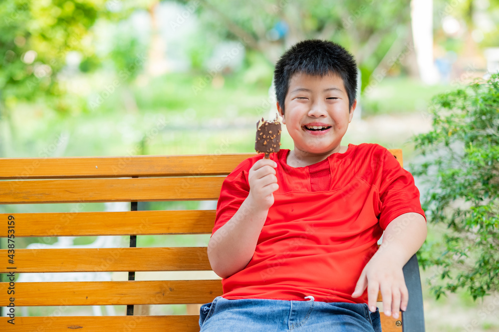 asian boy eating ice cream, summer season asian boy eating ice cream, summer season