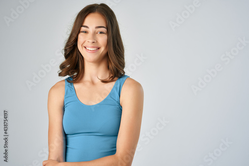brunette in blue t shirt fashion lifestyle light background model