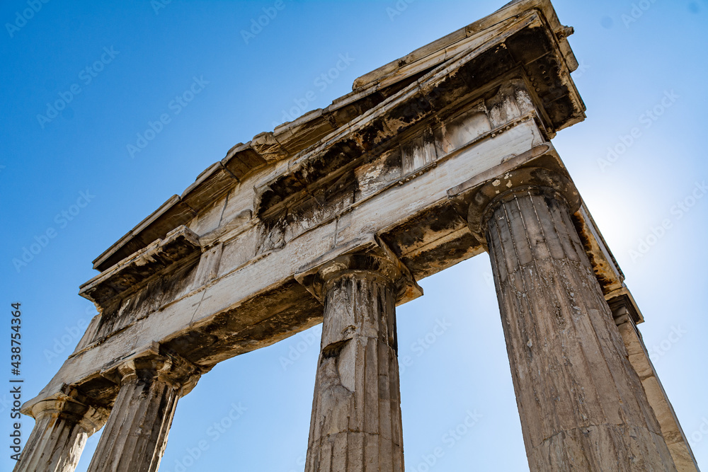 Ancient columns at the entrance to the Roman Agora in Athens Greece against the sun